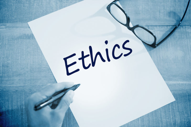 The word ethics against left hand writing on white page on worki Medical industry logos
